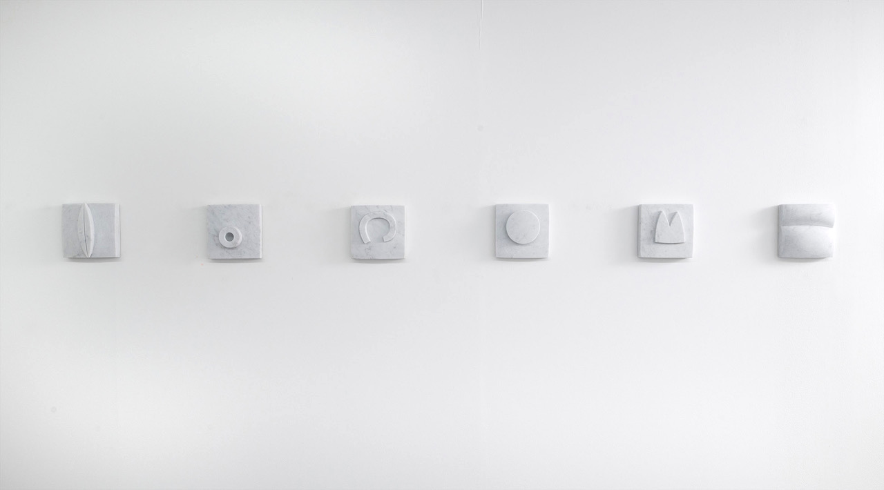 Jake Harvey, installation view of white Carrara marble carved wall relieves, each 18 x 18 cm