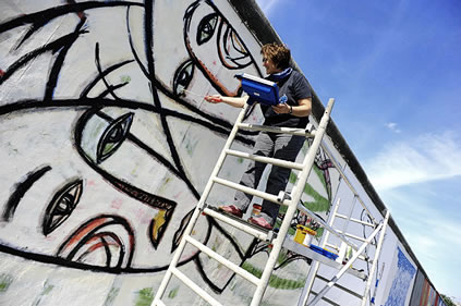 Margaret Hunter, Renovating Berlin Wall painting, 2009