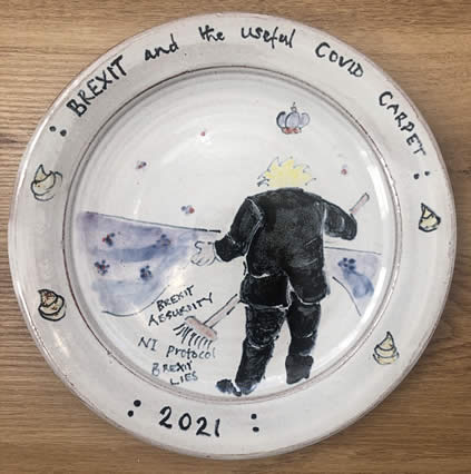 Molly Attrill, <em>Brexit and the Useful Covid Carpet</em>, maiolica plate, 23 cm diameter, from a series of 30 titled Shysters and Charlatans, Maiolica for our Times